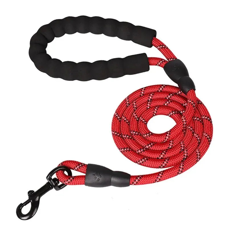 Red climbing rope dog leash with black padded handle and reflective safety stitching.